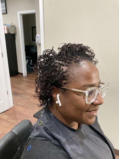 A woman sitting in a chair with a pair of glasses on her head