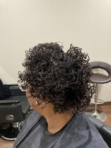 A woman sitting in a chair in a hair salon